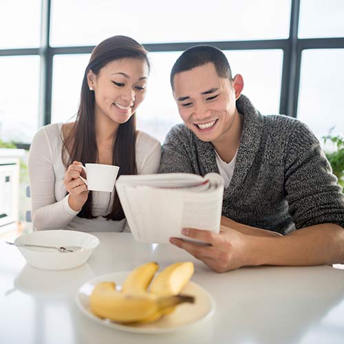 Couple reviewing paperwork together at their kitchen table