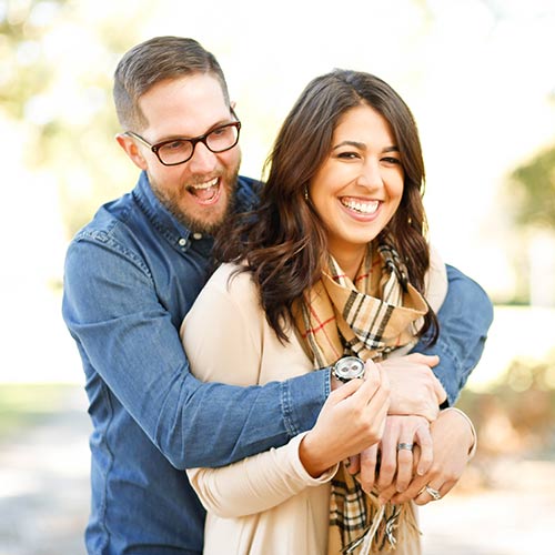 Smiling couple standing together outdoors